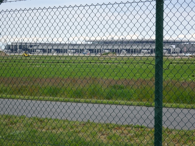 Fußwegbrücke für Einschiffung der Nutzer zum Flugzeug am Punkt A 38, auf dem Bild rechts vom grünen Pfahl